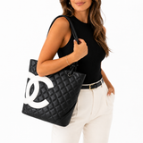 Model wearing the Chanel Cambon black and white lambskin tote