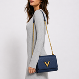 Model wearing the blue Epi leather bag with the owner-confirmed gold V closure