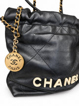 Chanel 22 bag, CHANEL PARIS gold-tone medallion charm detail