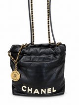 Chanel 22 bag in black calfskin with gold-tone hardware, front with CHANEL lettering
